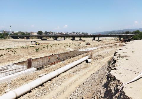 Construction work of the Tawi River Front Project is in full swing, in Jammu on Monday.