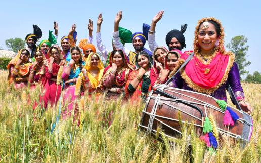 Baisakhi Greetings To All Our Readers: Artists dressed in traditional Punjabi attires pose for a photo celebrating in the fields ahead of Baisakhi, in Jalandhar on Wednesday.