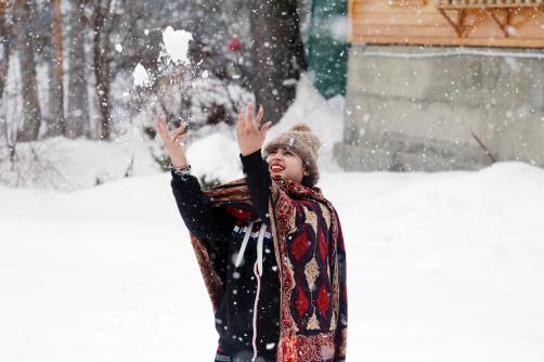 A woman playing with snow after fresh snowfall in the upper reaches of Tangmarg in north Kashmir Baramulla district on Tuesday.