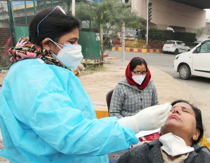 A healthcare worker collects the nasal swab sample for COVID-19 testing in wake of a surge in Omicron-driven Coronavirus cases, in Jammu on Wednesday.