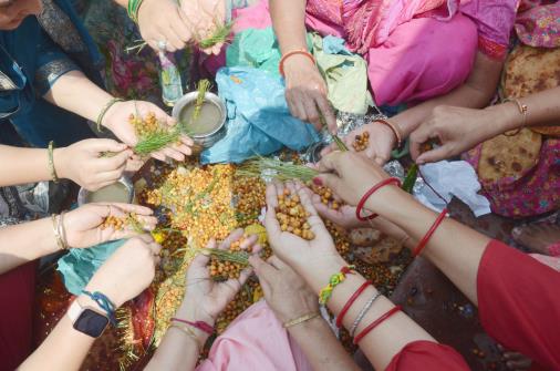 Devotees perform rituals while praying for the long life for their children during the Baccha Dua festival celebrations, in Jammu on Tuesday.