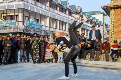 Football freestylers Aguska Minch and Patrick Baurer perform in front of the Clock tower, Lal Chowk in Srinagar on Monday.